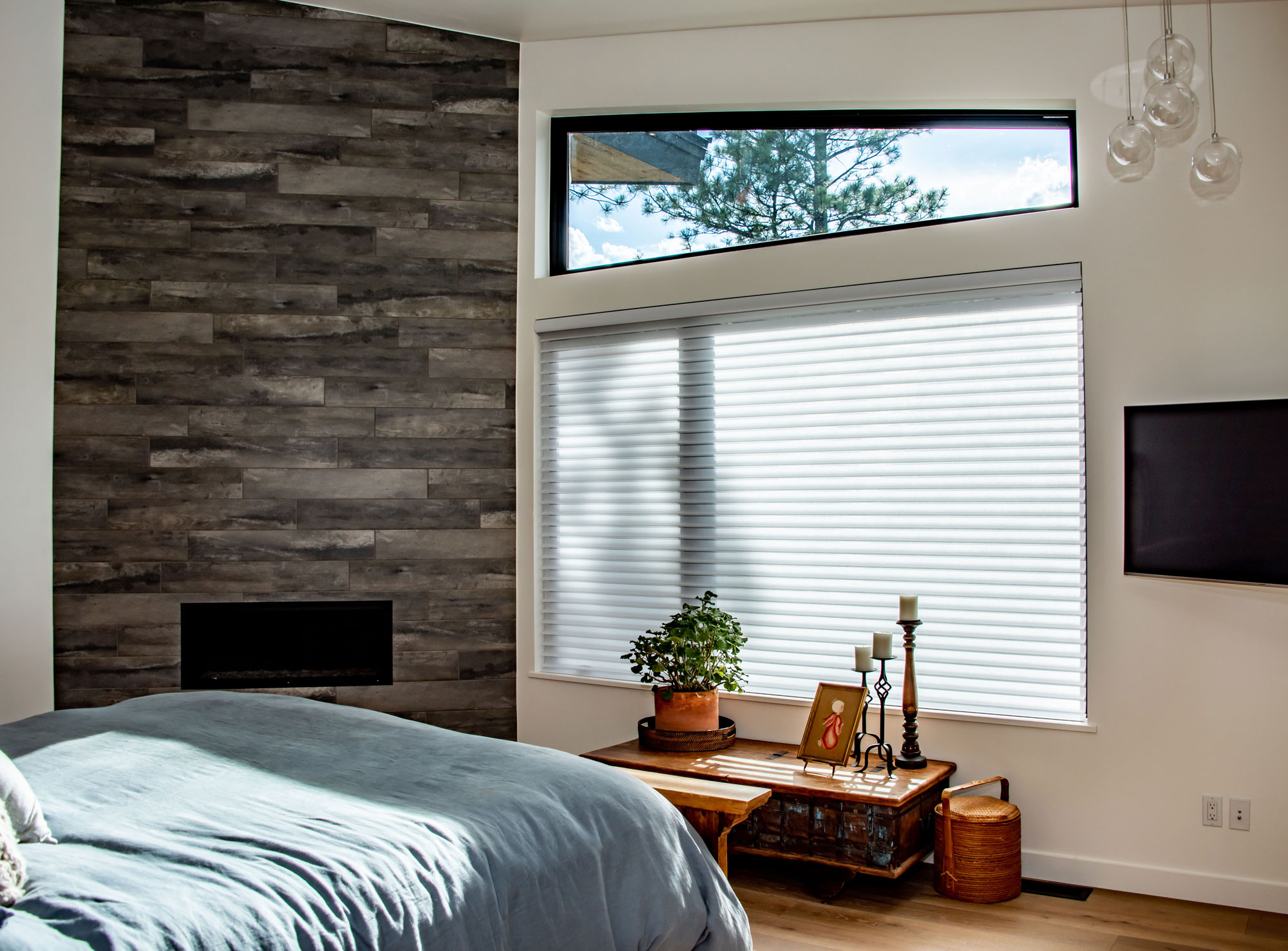 Contemporary bedroom with large window, wooden accents, and minimalist decor.