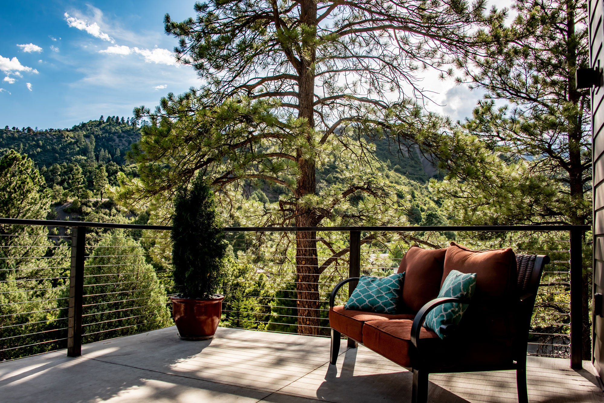 Outdoor balcony with seating and scenic mountain views at Rock Ridge.