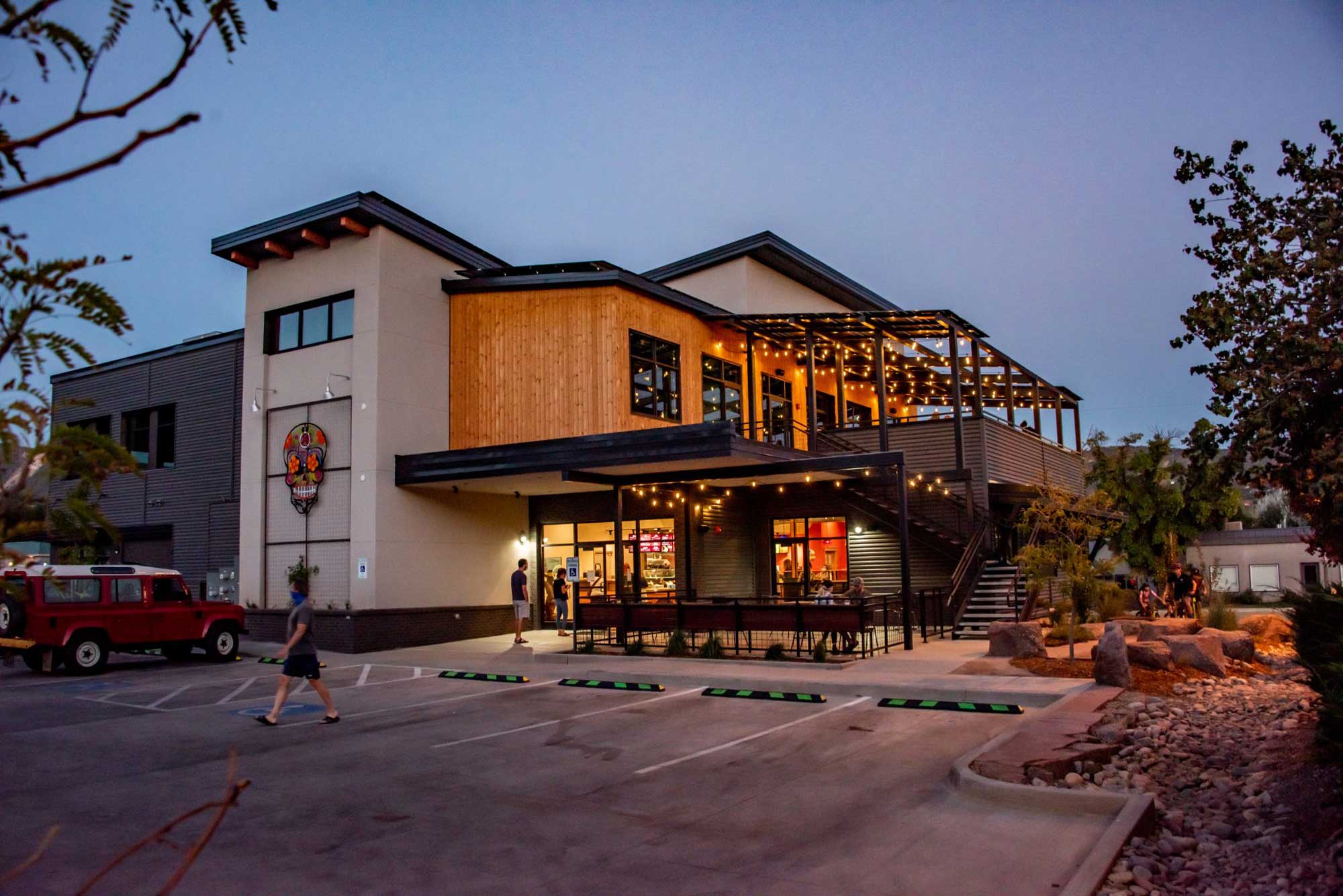 Modern Zia Taqueria restaurant with outdoor seating and warm lighting.