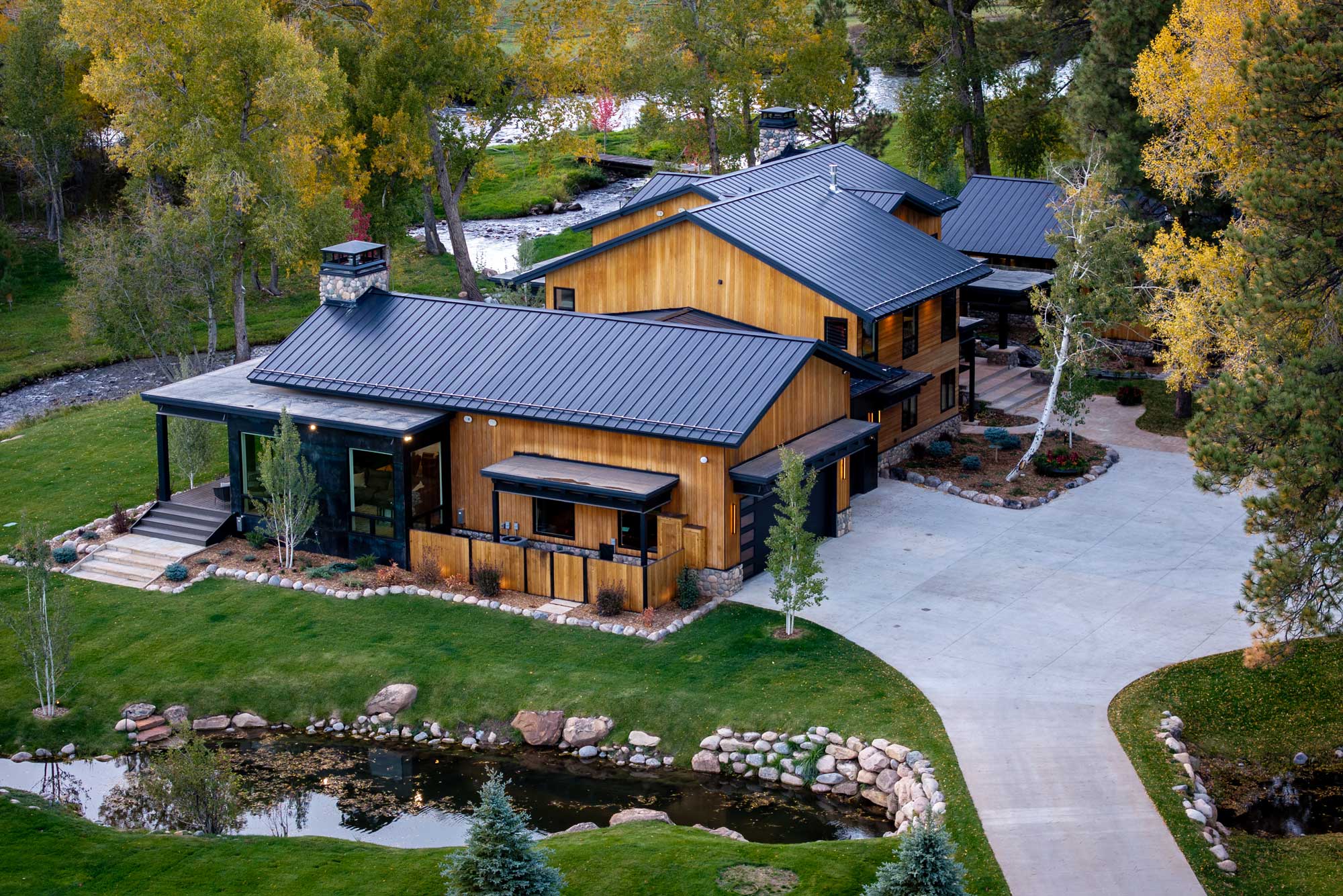 Modern ranch-style home with wooden exterior and metal roof.