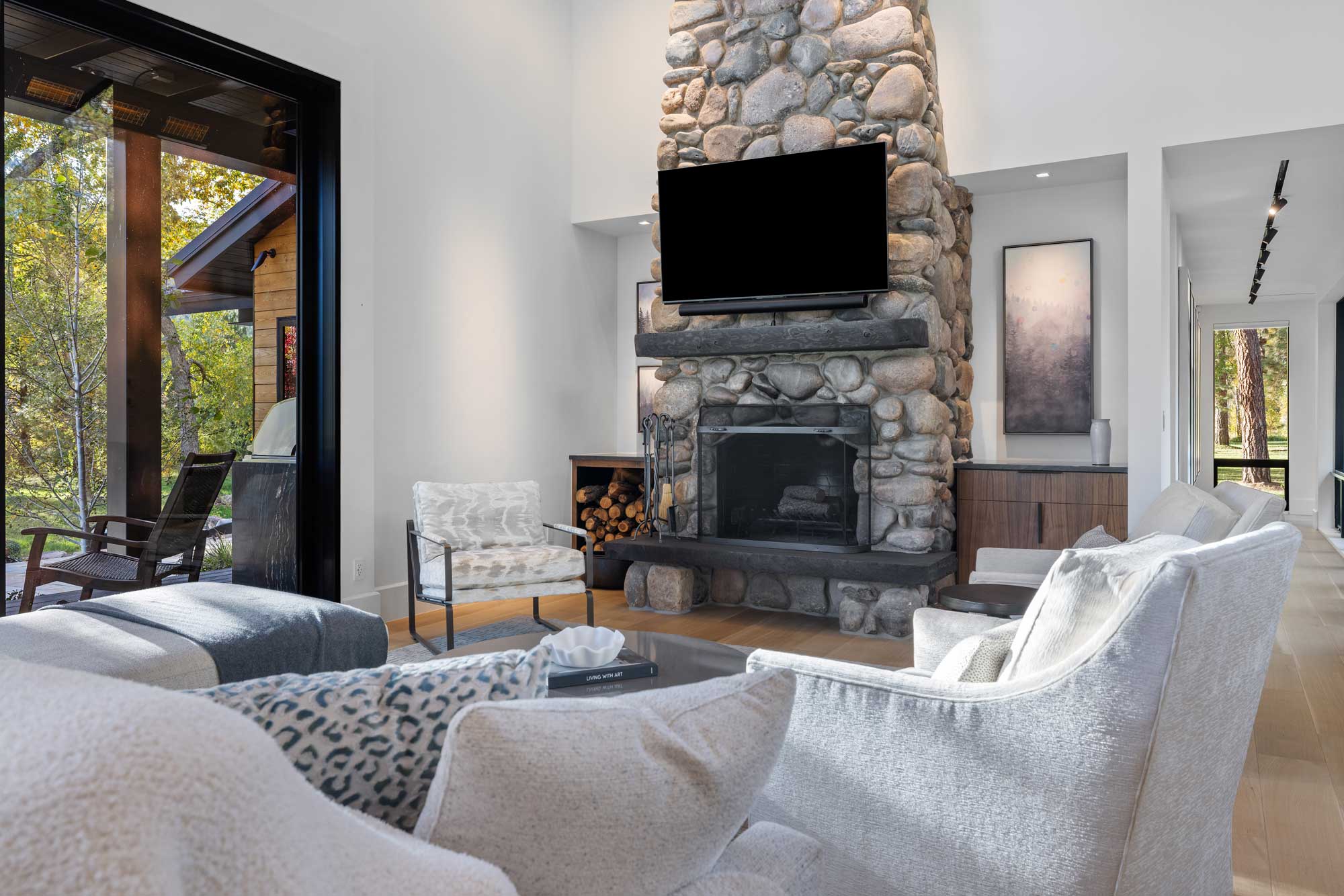 Elegant living room with stone fireplace and modern decor.