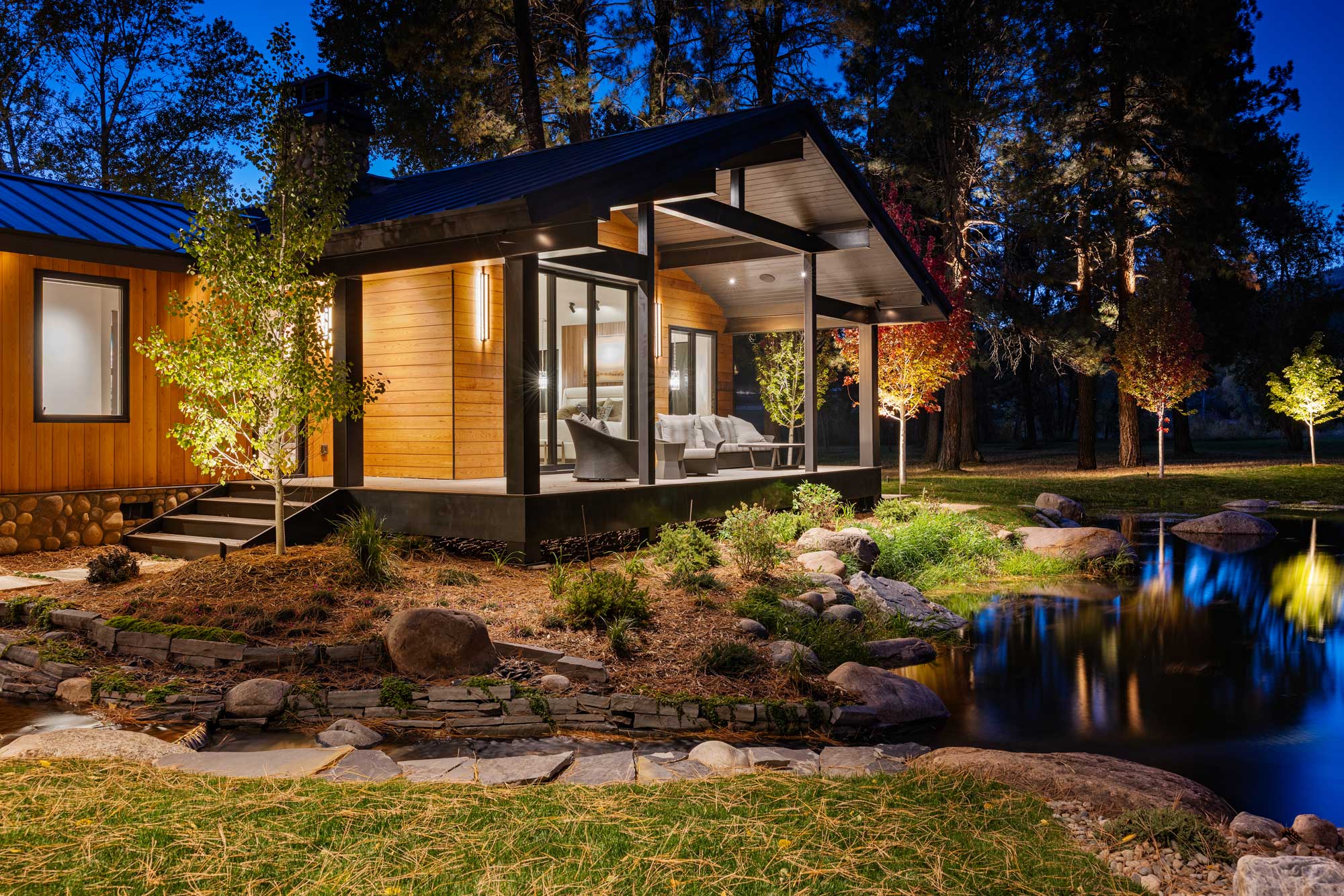 Modern ranch-style home with large glass windows and wooden exterior.