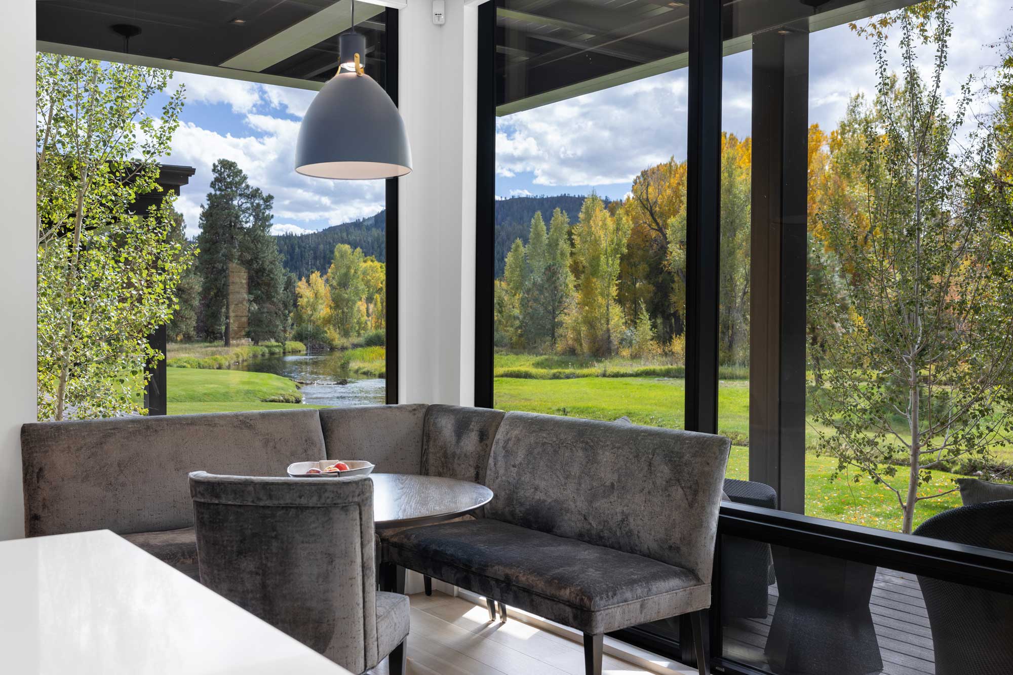 Modern ranch home interior with large windows showcasing scenic outdoor views.