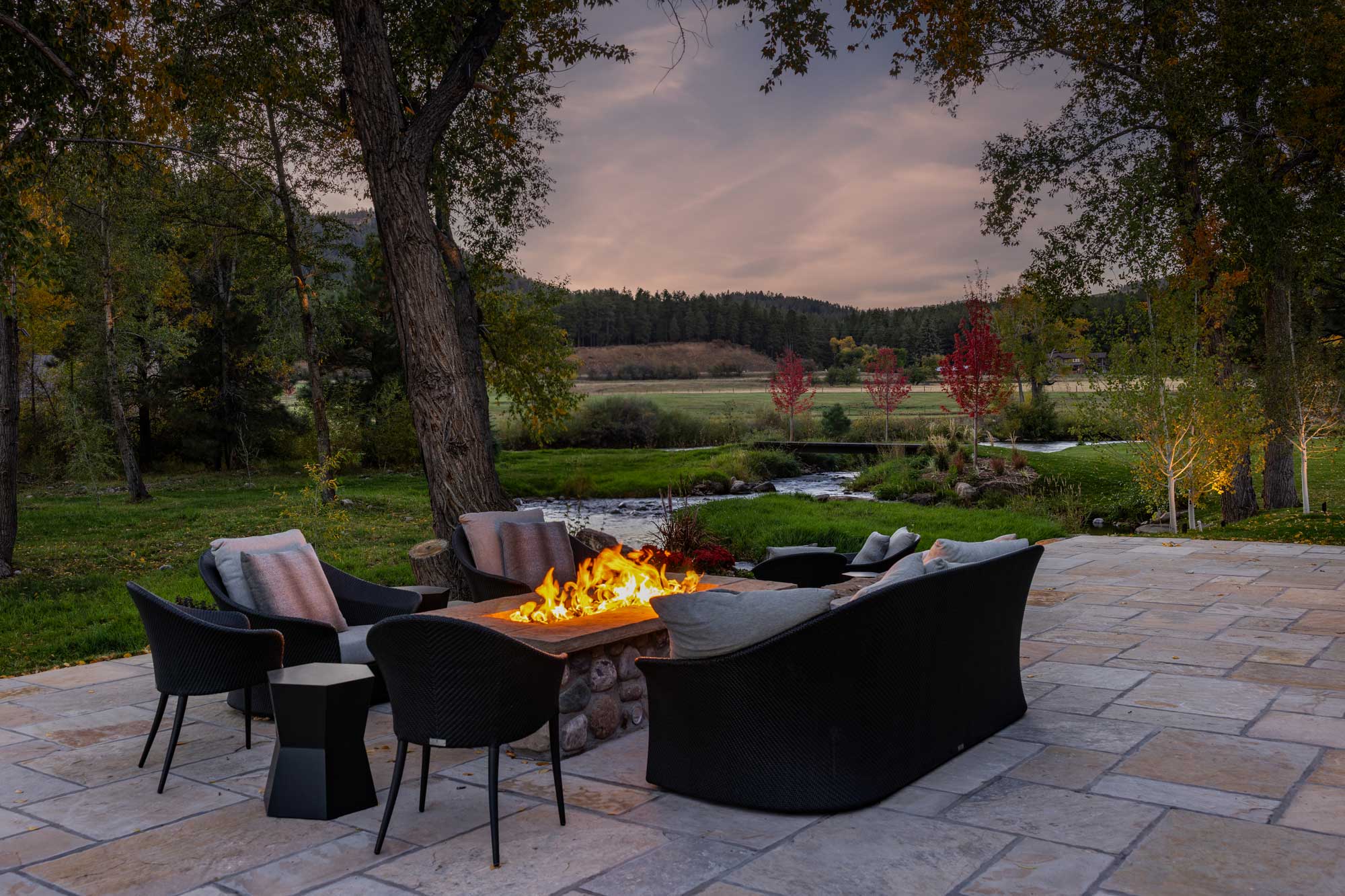 Outdoor fire pit with seating at Grey Hackle Ranch.