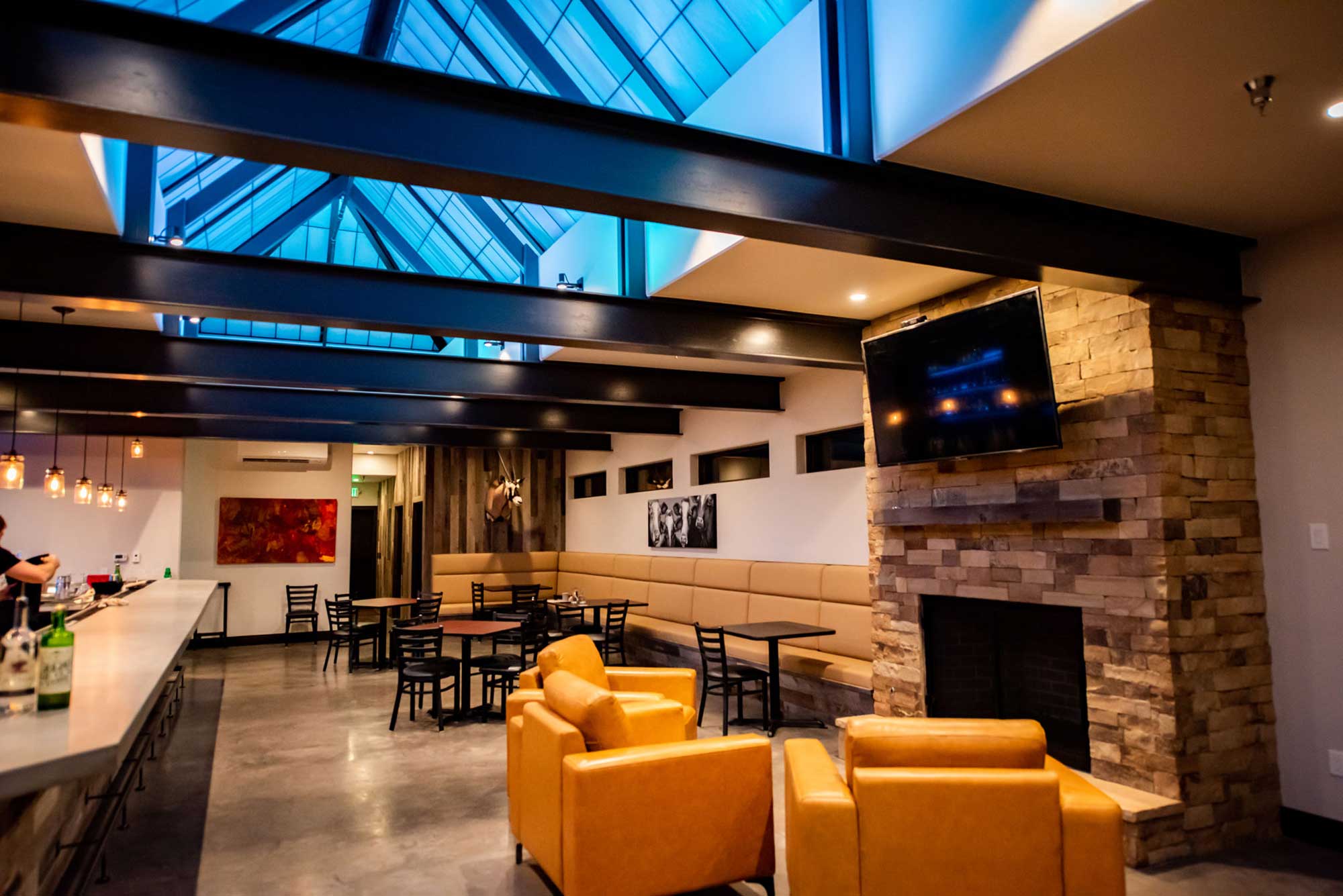 Interior of Alley House Grille showcasing stylish furniture and warm ambiance.