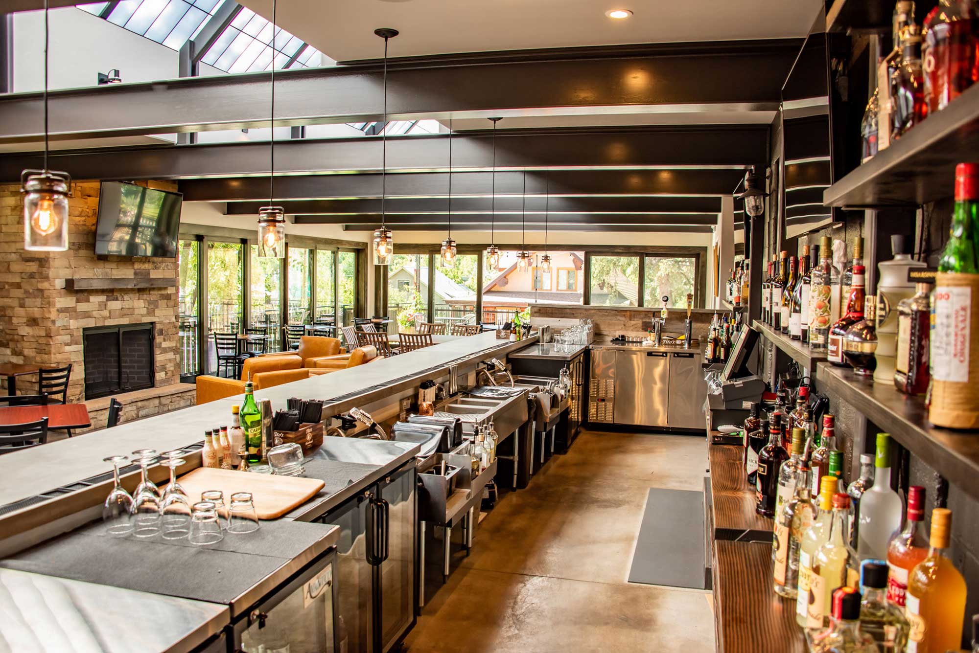 Alley House Grille bar interior with a sleek, contemporary design and well-stocked shelves.