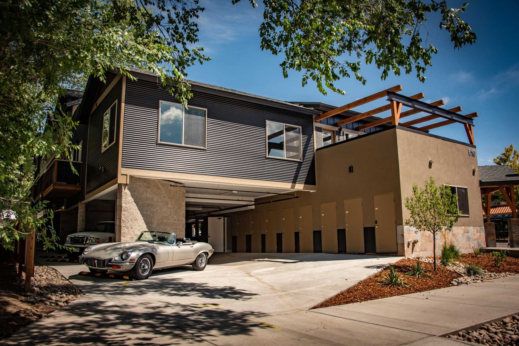 Modern East Side Lofts architectural design with sleek black siding and spacious balcony.