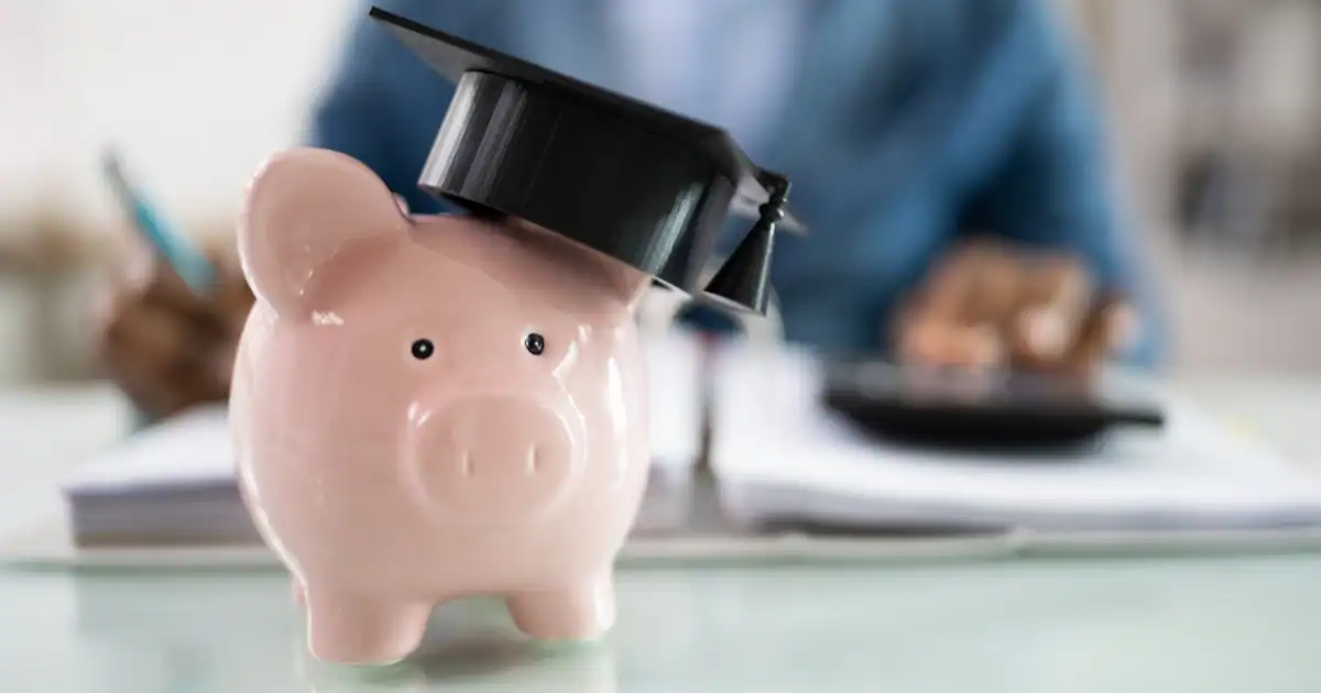 Piggy bank with black graduation hat
