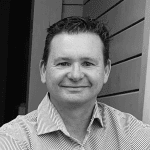 Gentleman in formal shirt smiling for rehab and physiotherapy services in Taranaki, New Zealand.