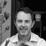 Professional man smiling at Rehab Taranaki clinic, rehabilitation and physiotherapy services in Taranaki, NZ.