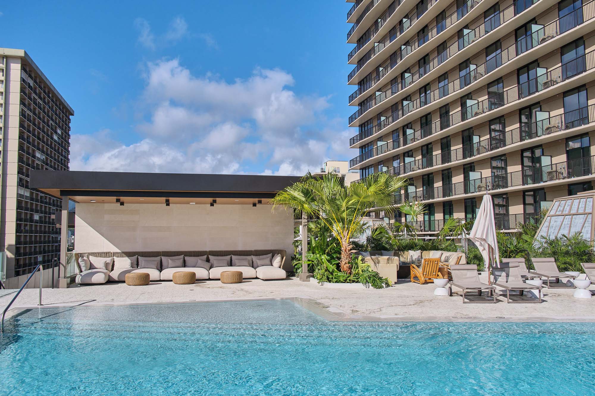 Resort-style pool with cabana with plush seating.