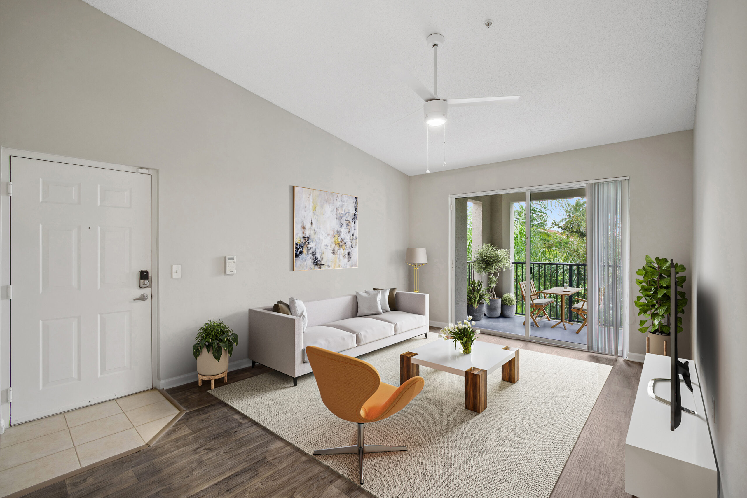 A living room with a couch, coffee table and a sliding glass door.