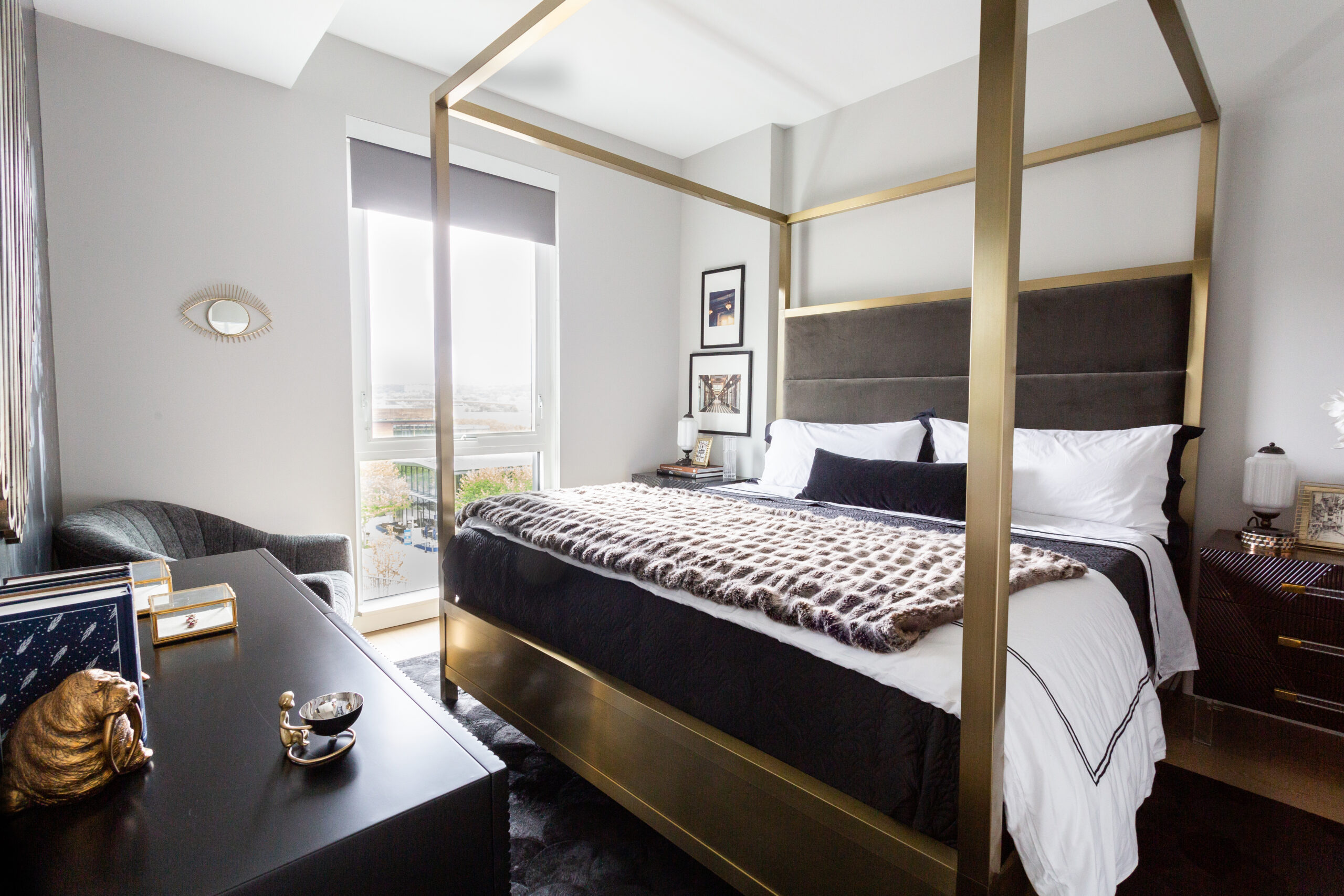modern apartment bedroom with canopy bed, nightstands, dresser, chair and large window