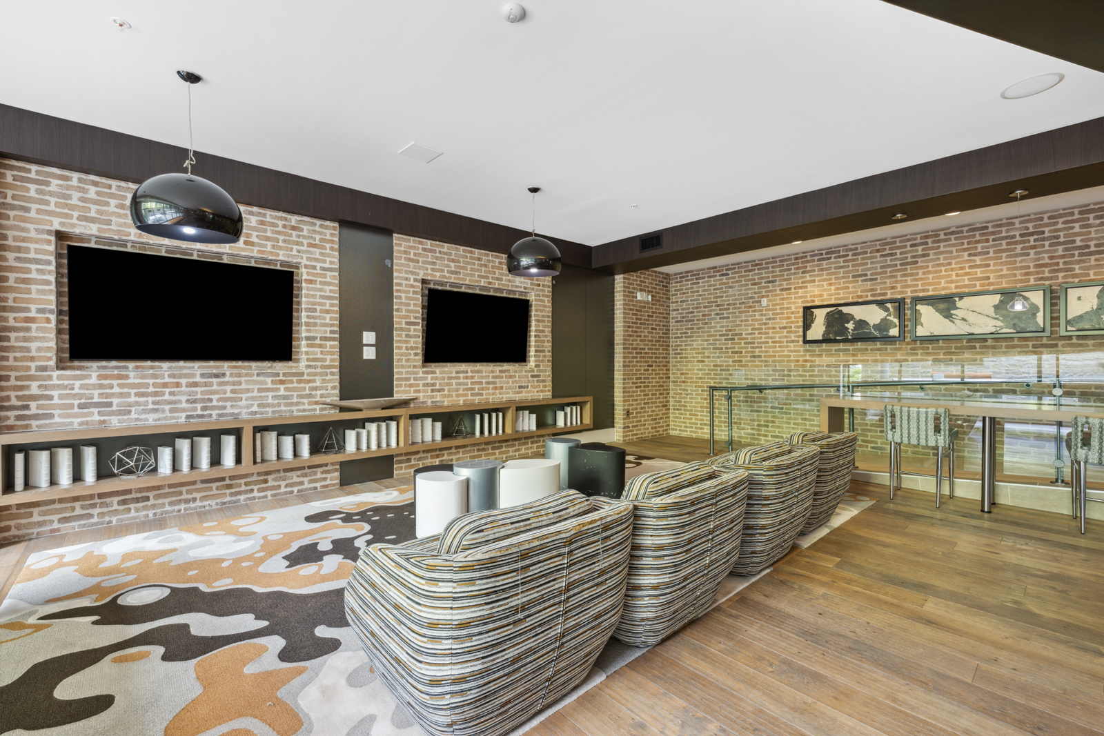 Amenity lounge with comfortable seating and flatscreens.