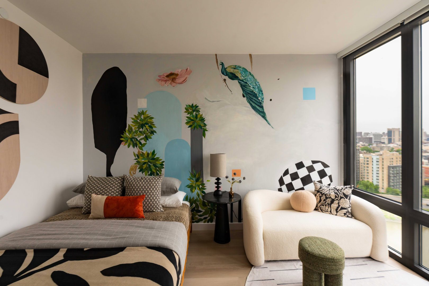 A bedroom with a large mural on the wall.