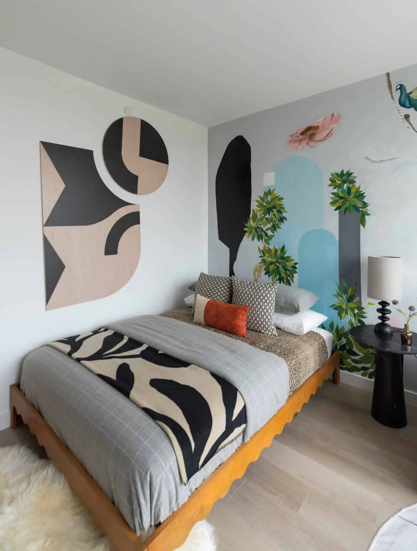 A bedroom with a large mural on the wall.
