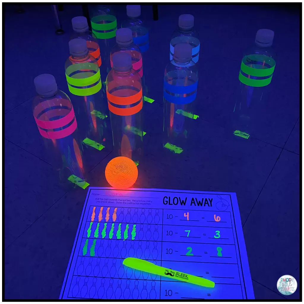 Empty water bottles set up for subtraction bowling activity. 