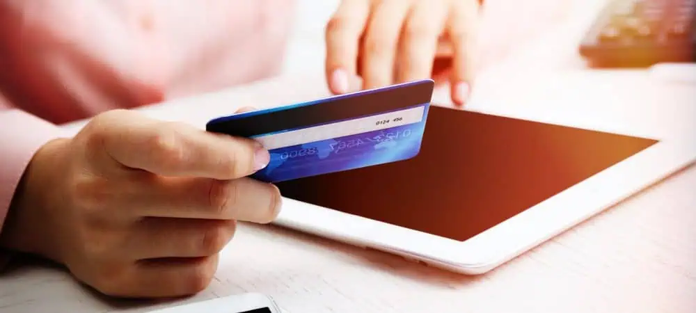 Woamn entering her credit card details online to sign up to a subscription service