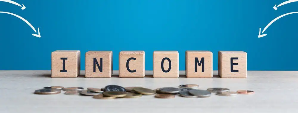 The word income spelt out with wooden blocks