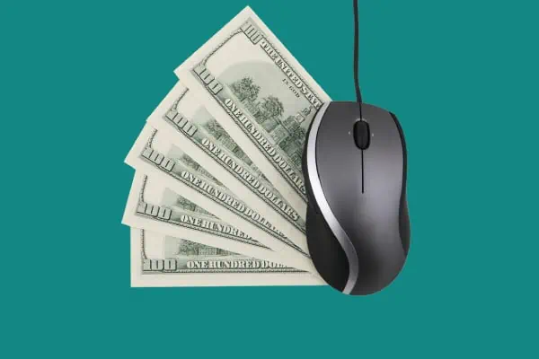 A computer mouse next to some cash