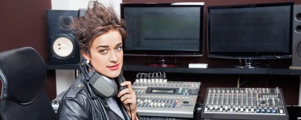 Woman sitting confidently in front of a podcast audio console
