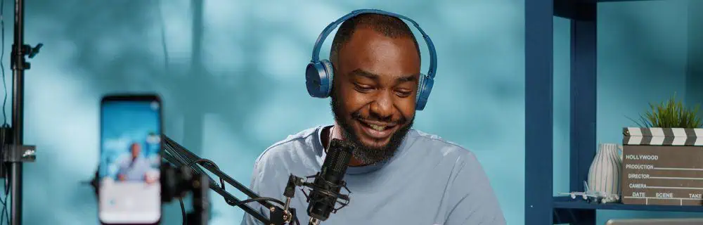 Podcaster wearing and using headphones while recording