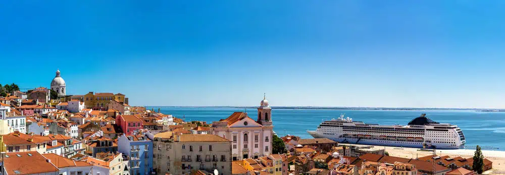 The city of Lisbon taken behind some houses overlooking the sea