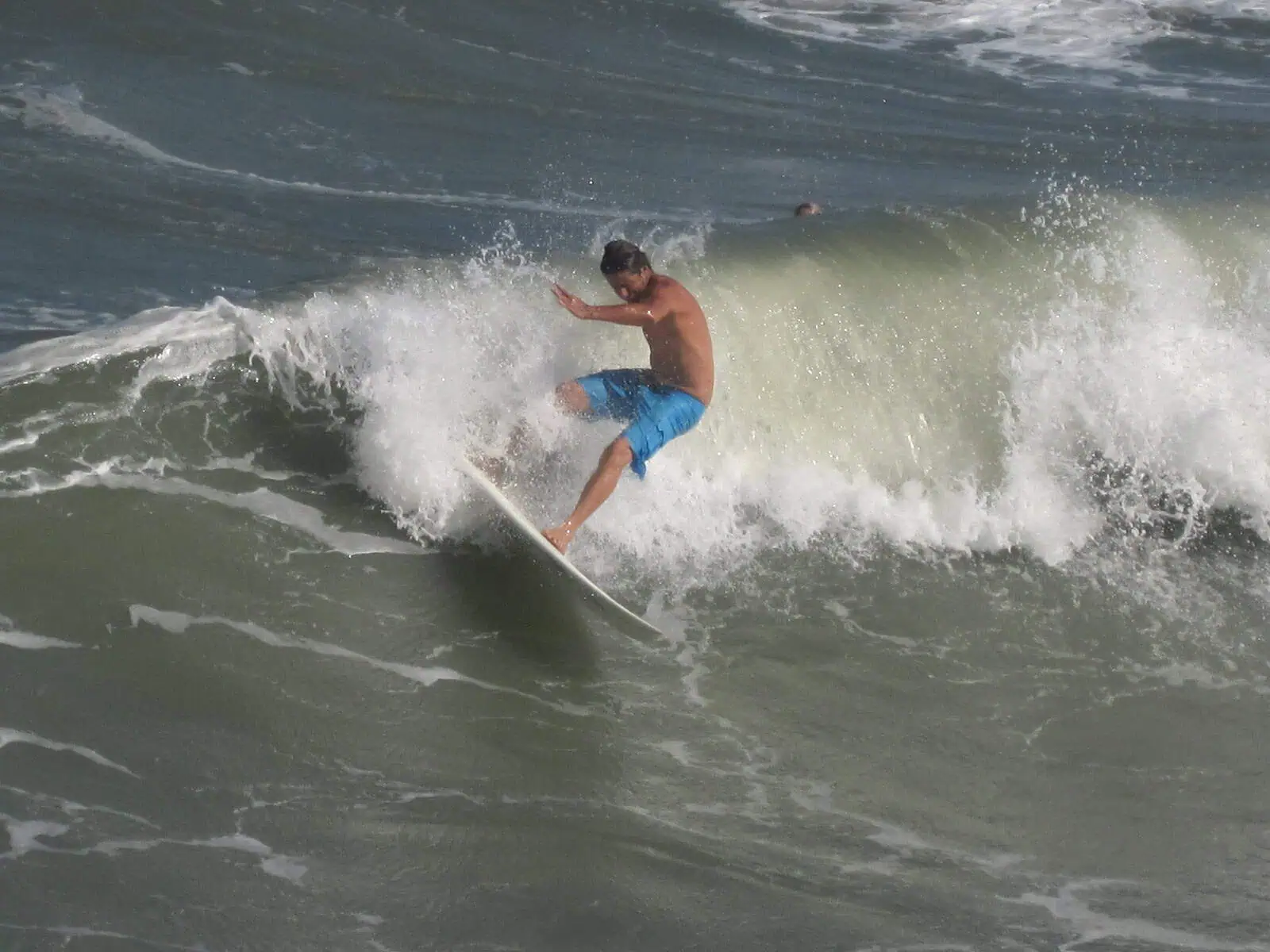 A man on a surf board riding the waves