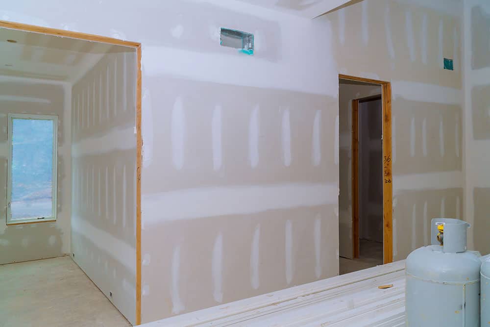 Interior construction of housing project with drywall installed door for a new home
