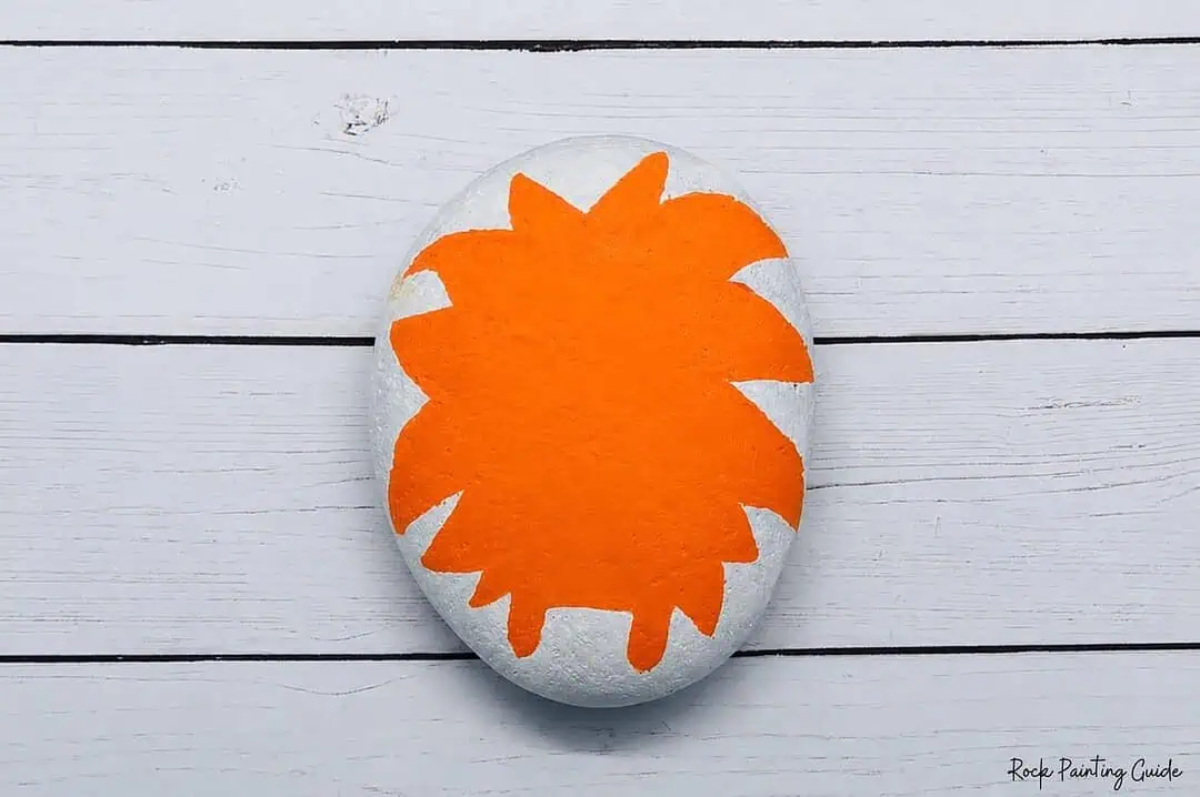 Easy Monster Rock Painting Tutorial: Fuzzy Halloween Rocks 4 paint the orange body of the mosnter rock painting