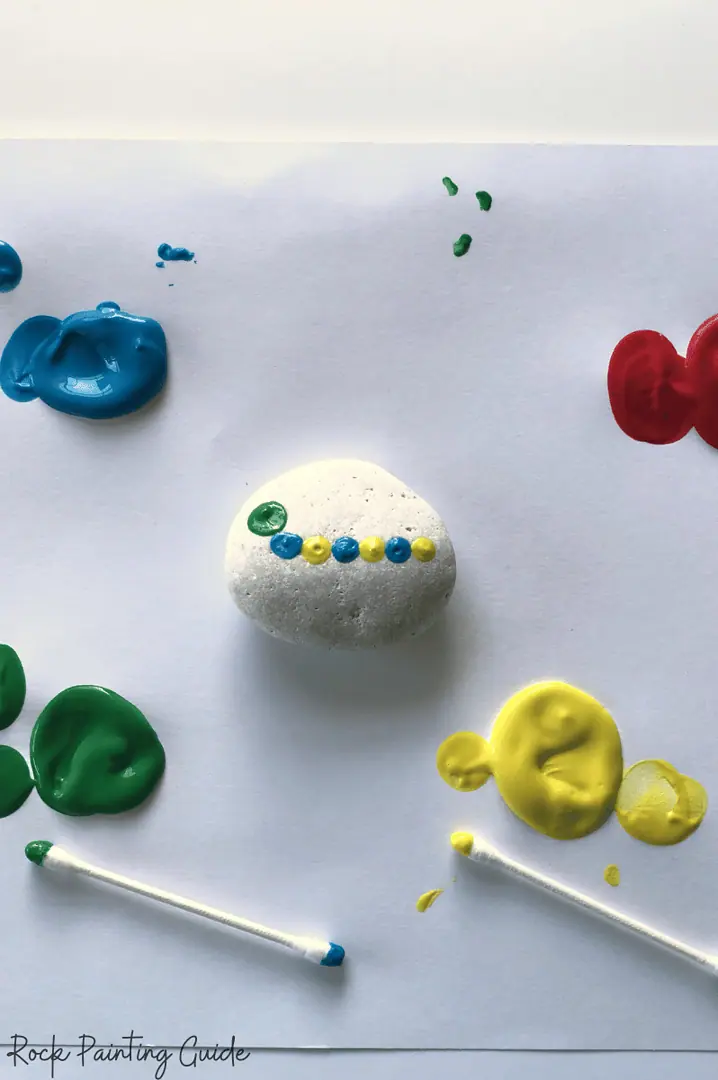 27 Fun Rock Painting Ideas For Preschoolers, No PaintBrush Required! 10 caterpillar rock painting in progress