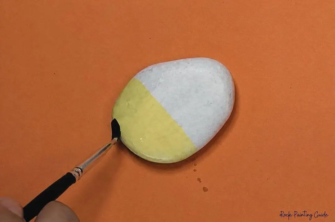Candy Corn Painted Rocks: Easy Alcohol Ink Rock Painting Tutorial 5 Painted rock resembling a candy corn with white, orange, and yellow sections.