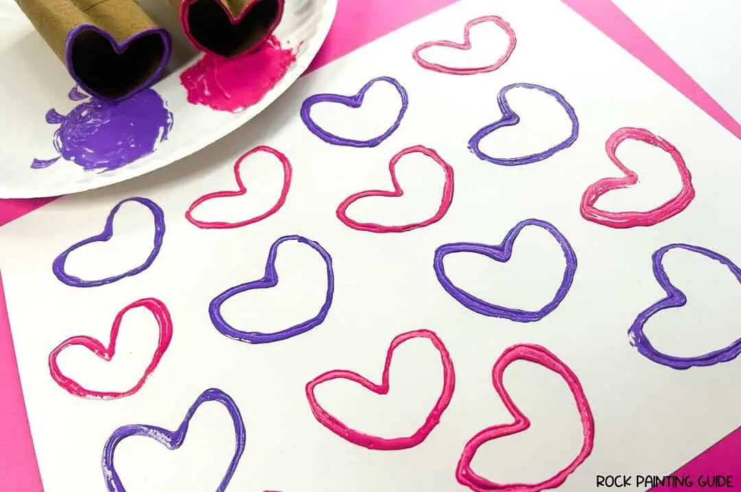 Create Valentine’s Day Fun with DIY Heart Stamp Craft 11 a plate of pink and purple paint on a white paper with pink and purple diy heart stamp art.