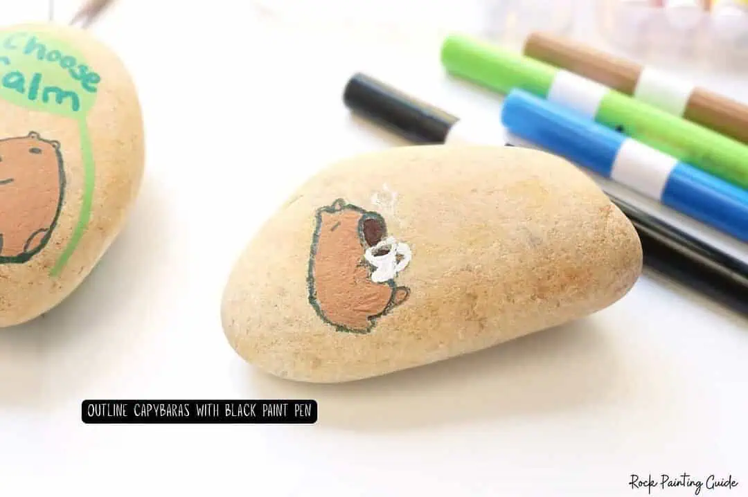 Create Capybara Painted Rocks for effortless Slow Living 7 Hand-painted bear on smooth rocks with colorful markers for creative rock painting.