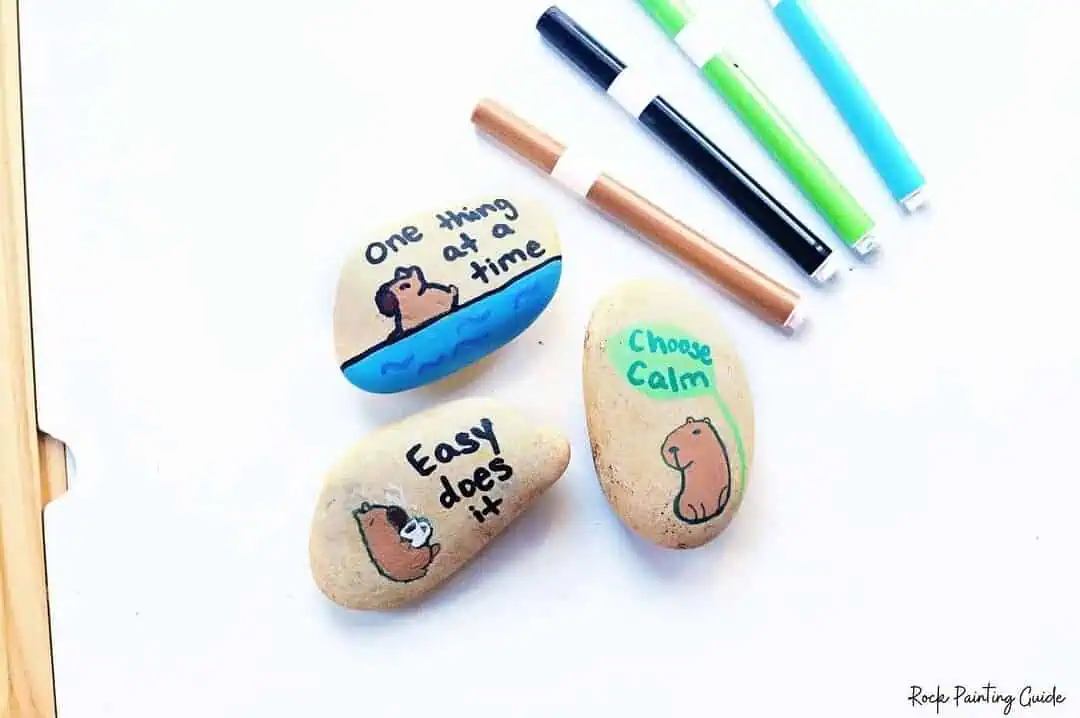 Create Capybara Painted Rocks for effortless Slow Living 9 Colorful painted rocks with motivational messages about calmness and positivity.