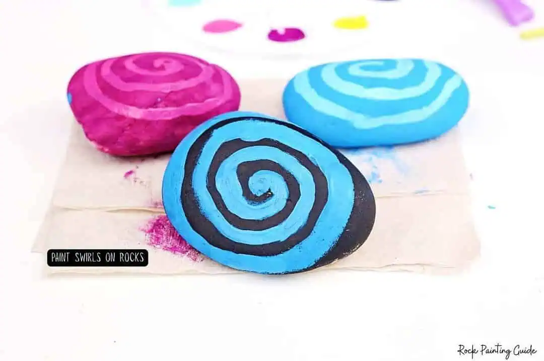 Easy Starry Night Sky Galaxy Painted Rocks for Beginners 6 Vibrant painted rocks with swirl patterns, perfect for DIY rock painting and art projects.