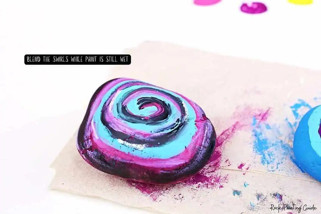 Easy Starry Night Sky Galaxy Painted Rocks for Beginners 7 Vibrant painted rock with swirl design, perfect for outdoor garden decor or craft projects.