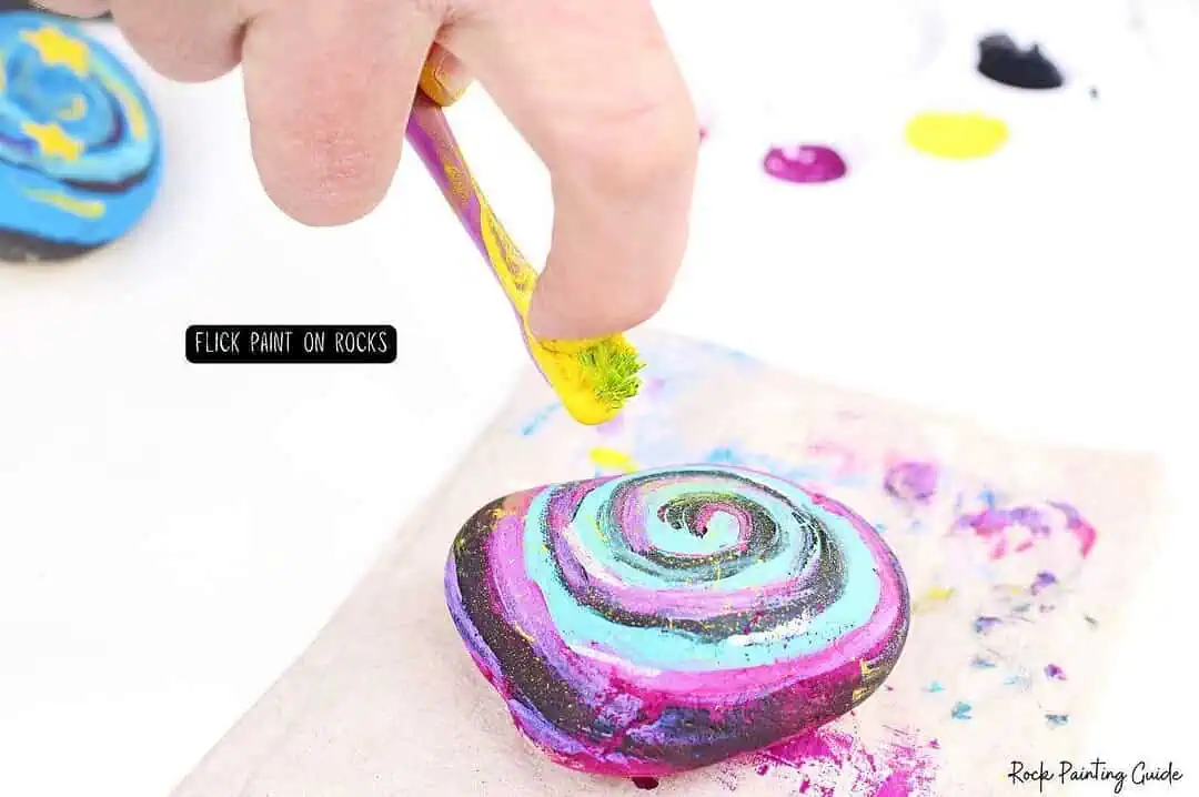Easy Starry Night Sky Galaxy Painted Rocks for Beginners 9 Vibrant spiral paint on smooth rock, perfect for rock painting art and craft projects.