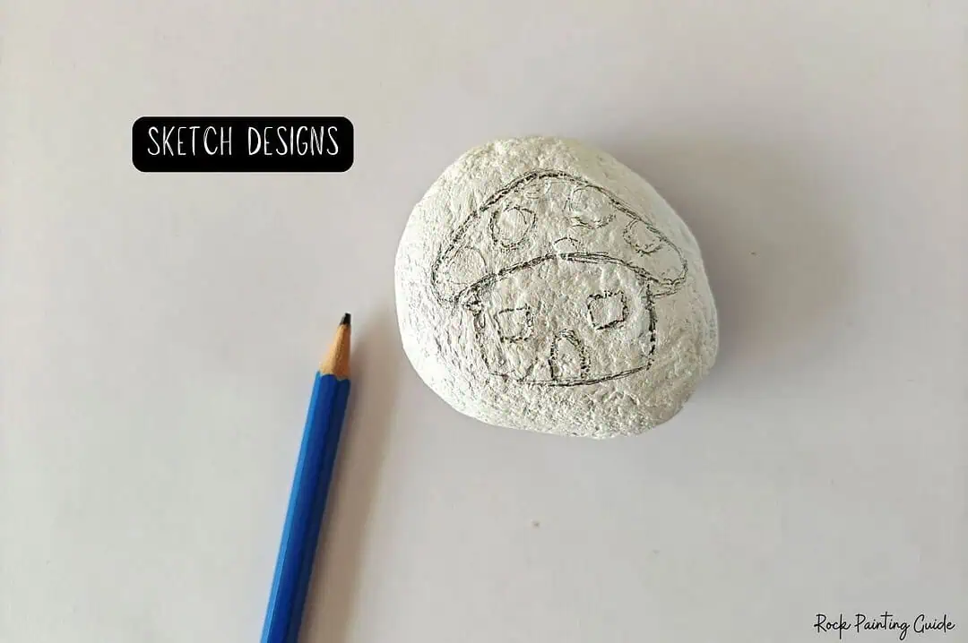 Cute Mushroom House Painted Rocks: Easy Fairy Garden DIY 6 Rock painting mushroom house design on a white stone for creative craft projects.