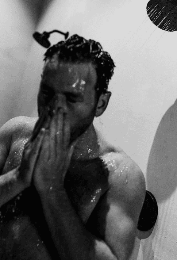 Guest cooling down with a rinse after a Nordic sauna session at ROK SPAS in Denver
