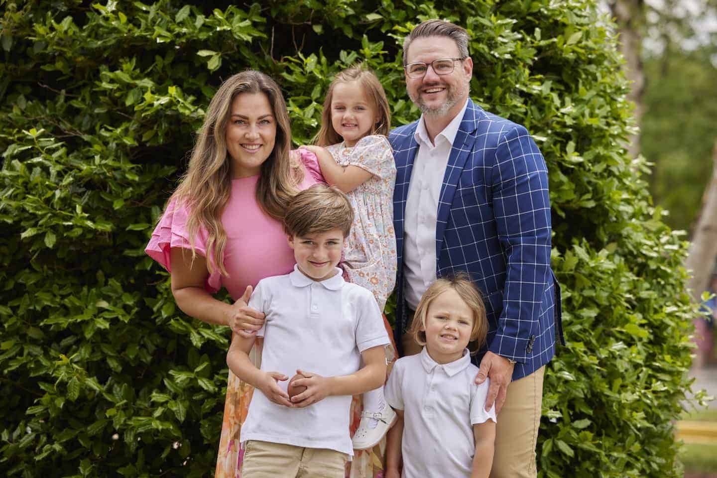 Family enjoying a sunny day together, showcasing community and faith.