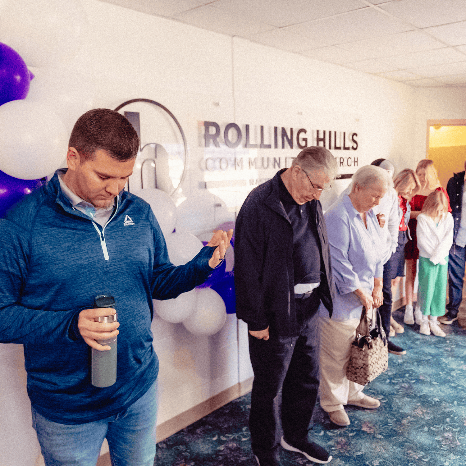 Community worship at Rolling Hills Community Church, people praying together.