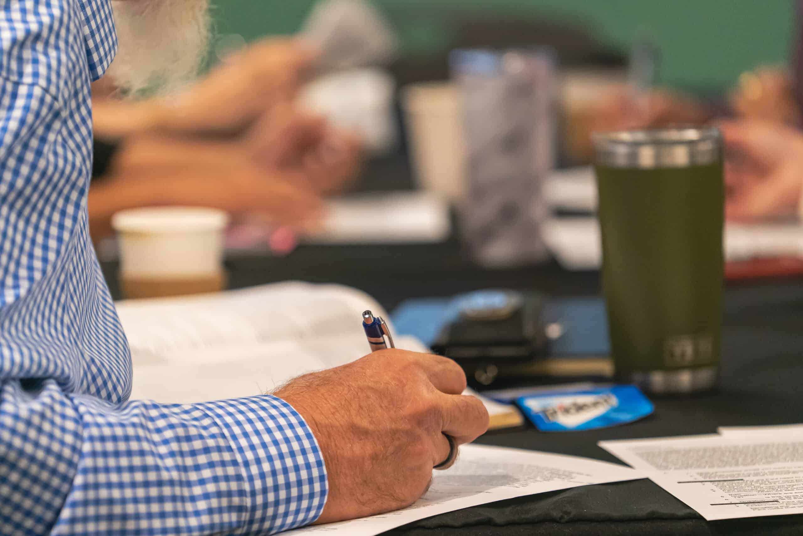 Attendees at Rolling Hills Community Church engaging in discussion and note-taking.