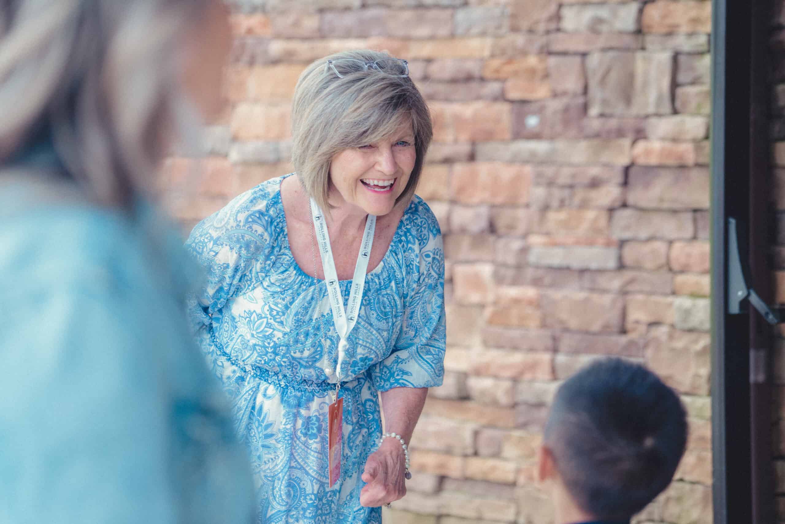 Woman smiling and engaging with children at Rolling Hills Community Church event.