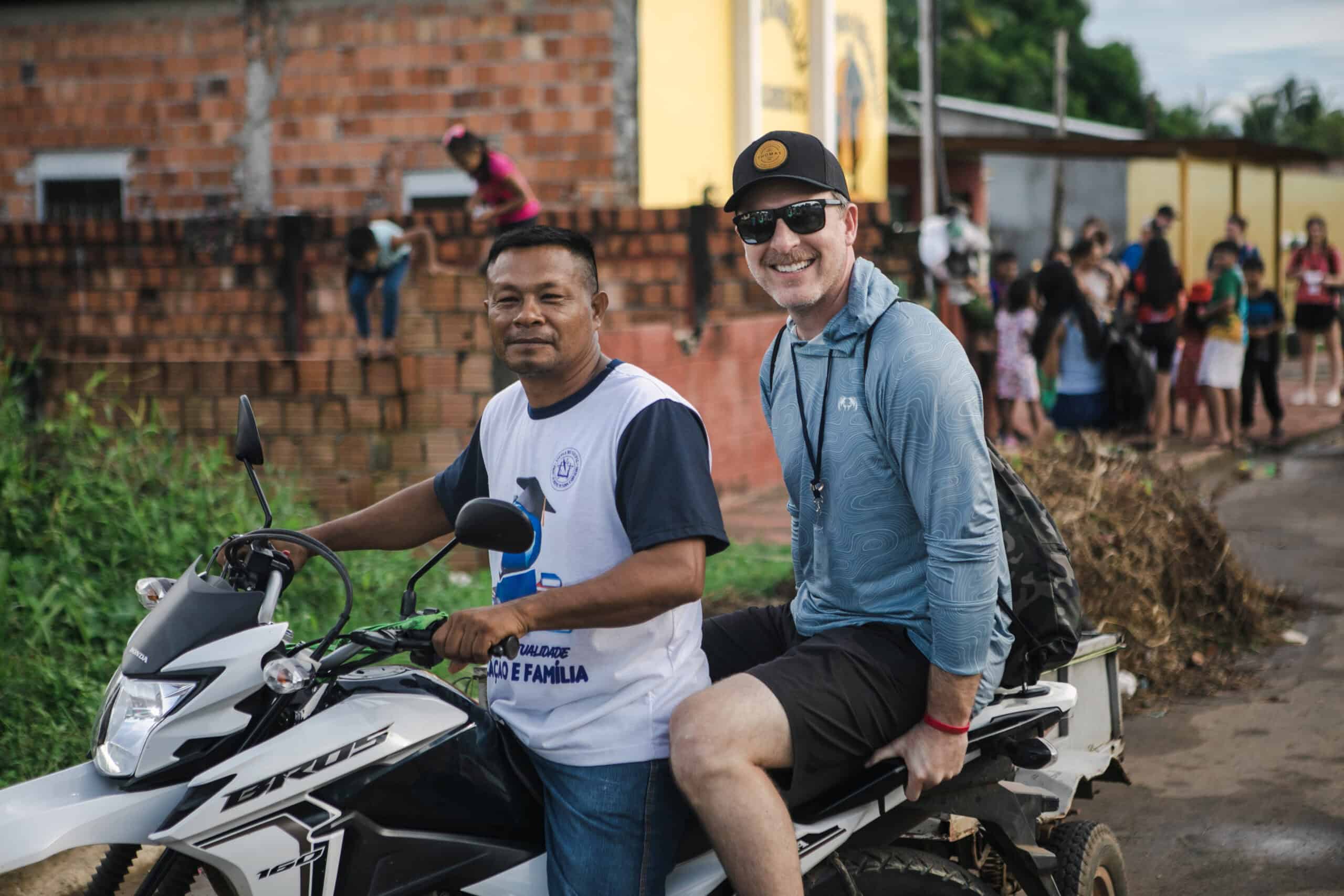 Two men on a motorcycle during a community outreach event at Rolling Hills Church.