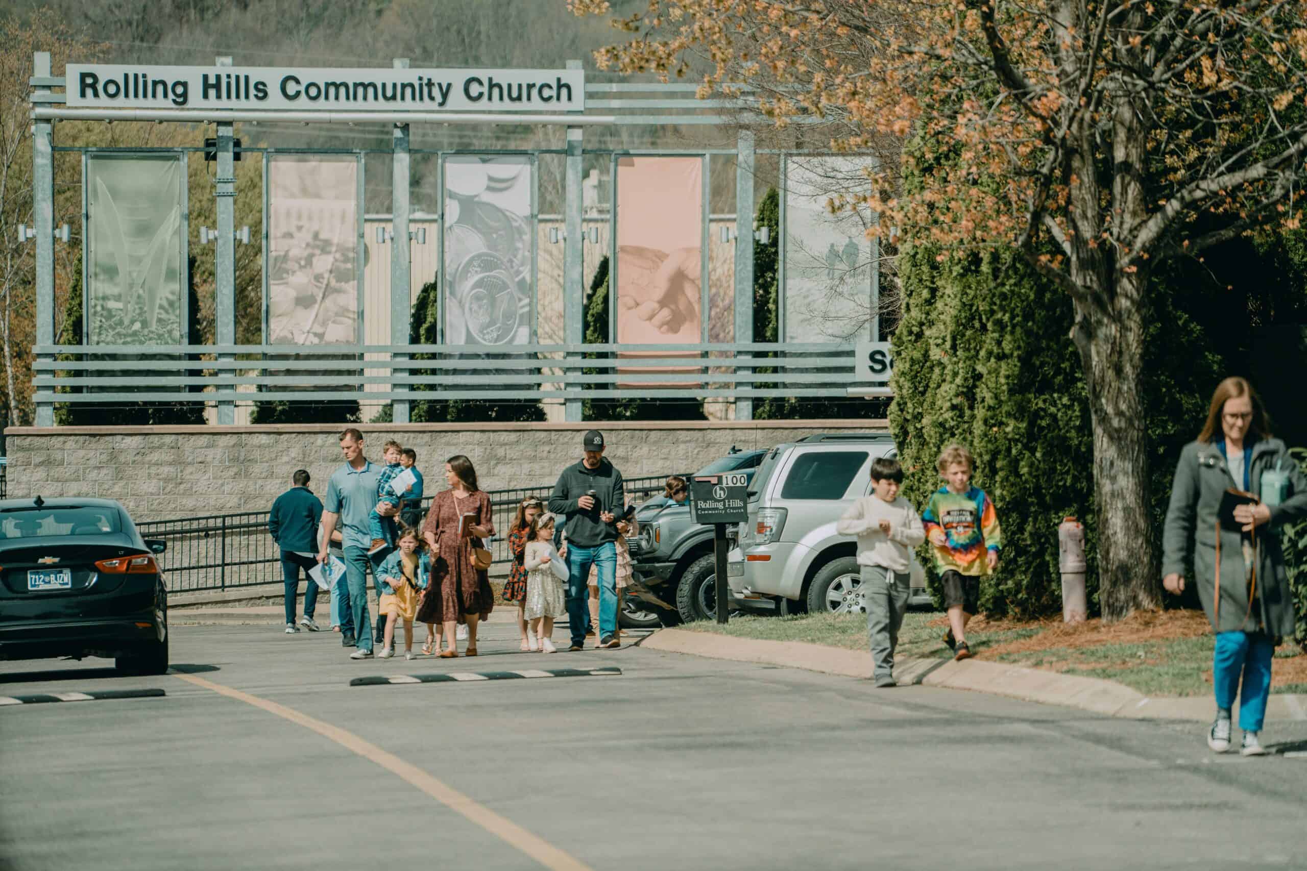 People entering Rolling Hills Community Church on a sunny day.
