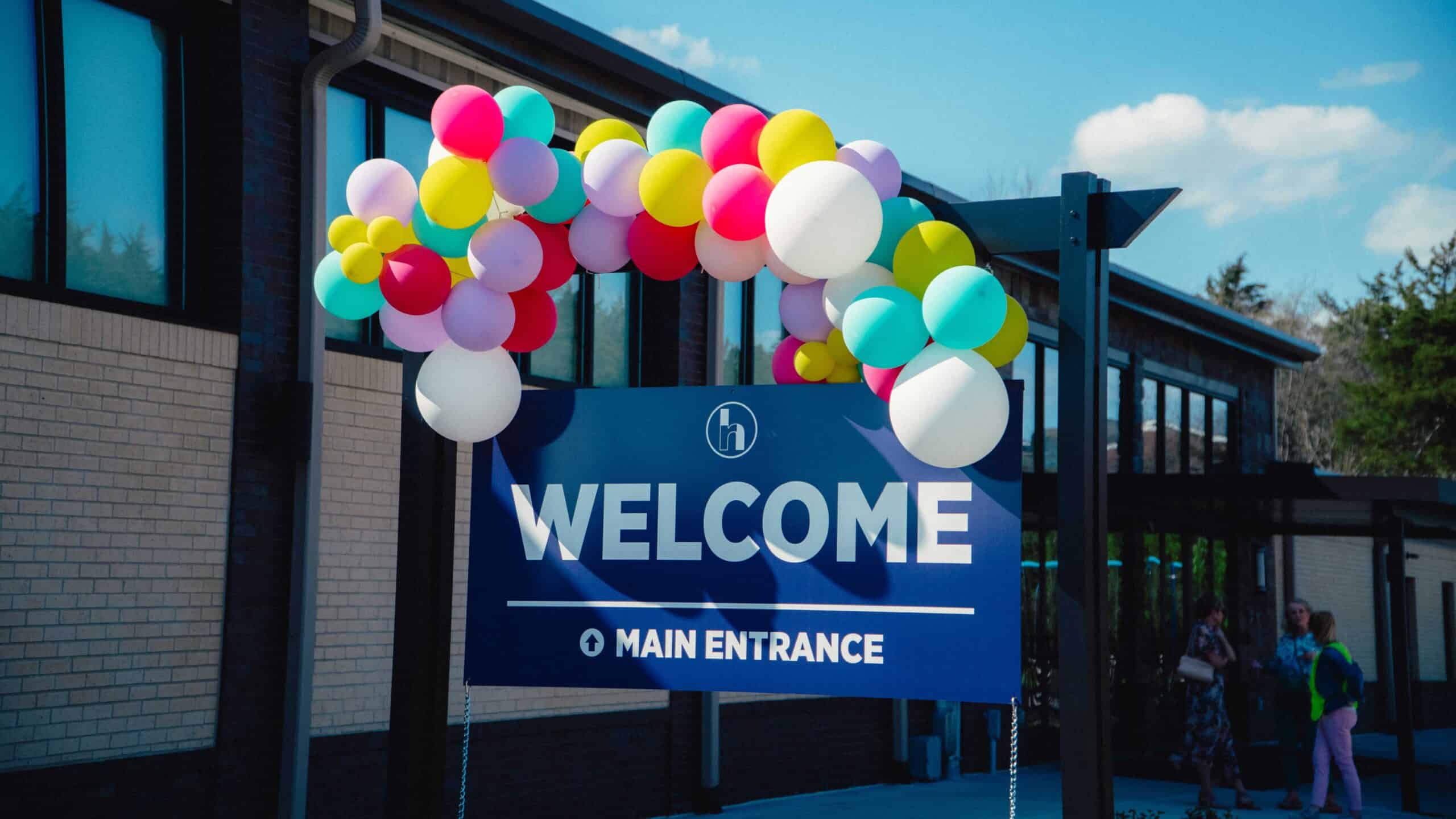 Welcoming entrance at Rolling Hills Community Church with colorful balloon arch and clear signage.