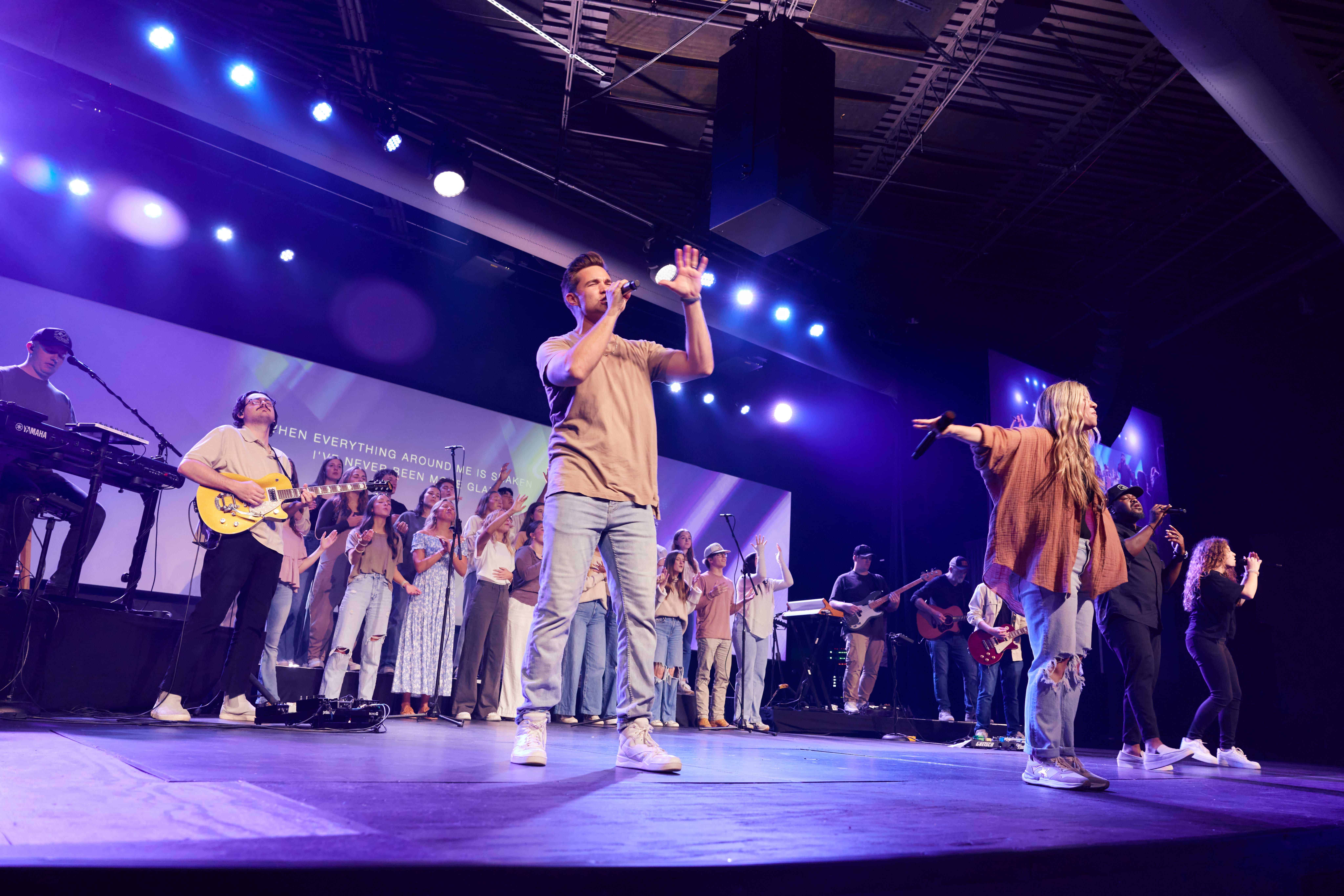 Worship team performing on stage at Rolling Hills Community Church with musicians and singers.