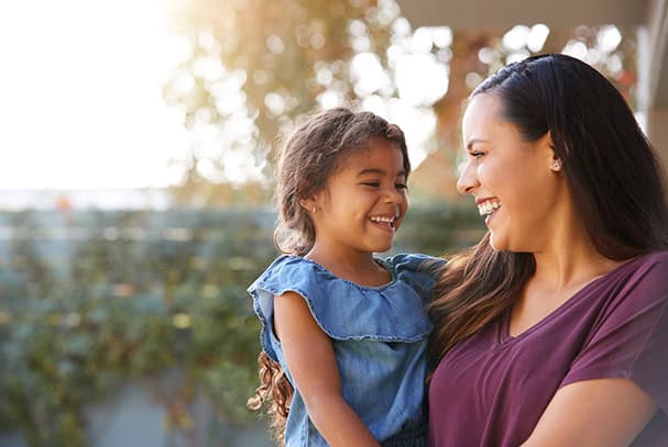 Happy mother and daughter sharing a joyful moment outdoors at Rolling Hills Community Church.