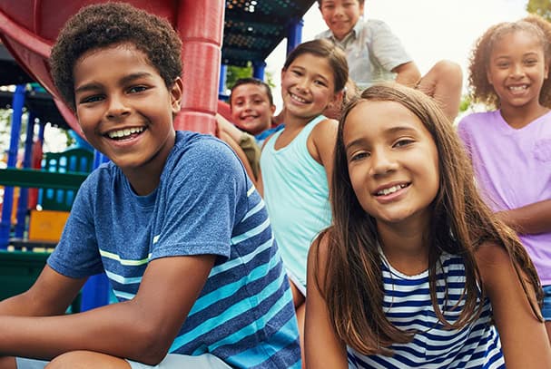 Children playing happily at Rolling Hills Community Church outdoor playground.